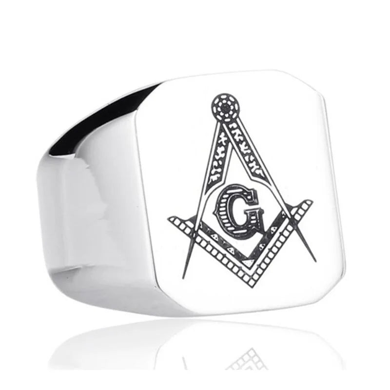 Close view of silver-tone Masonic face and outlined emblem