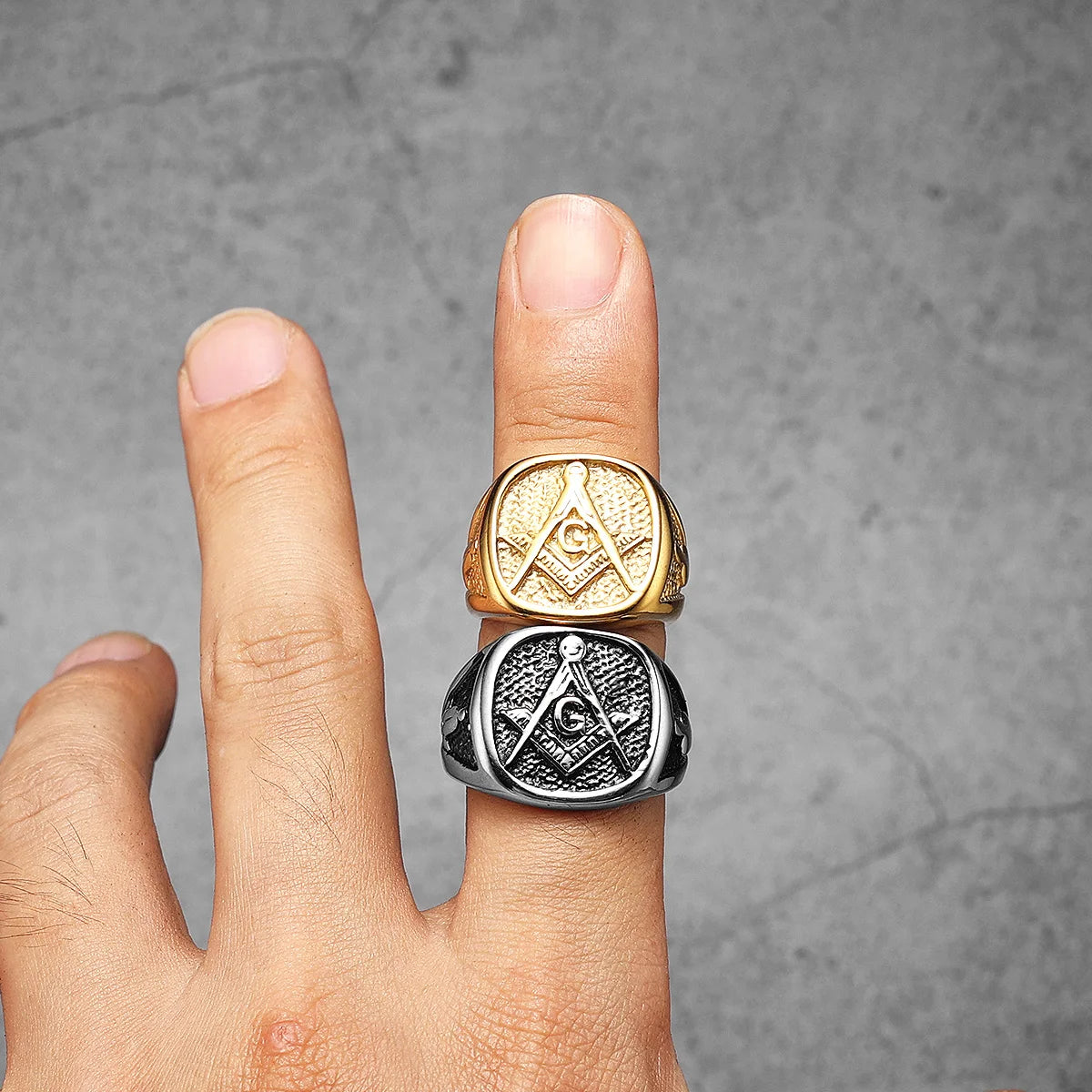 Two textured Masonic signets together on a hand