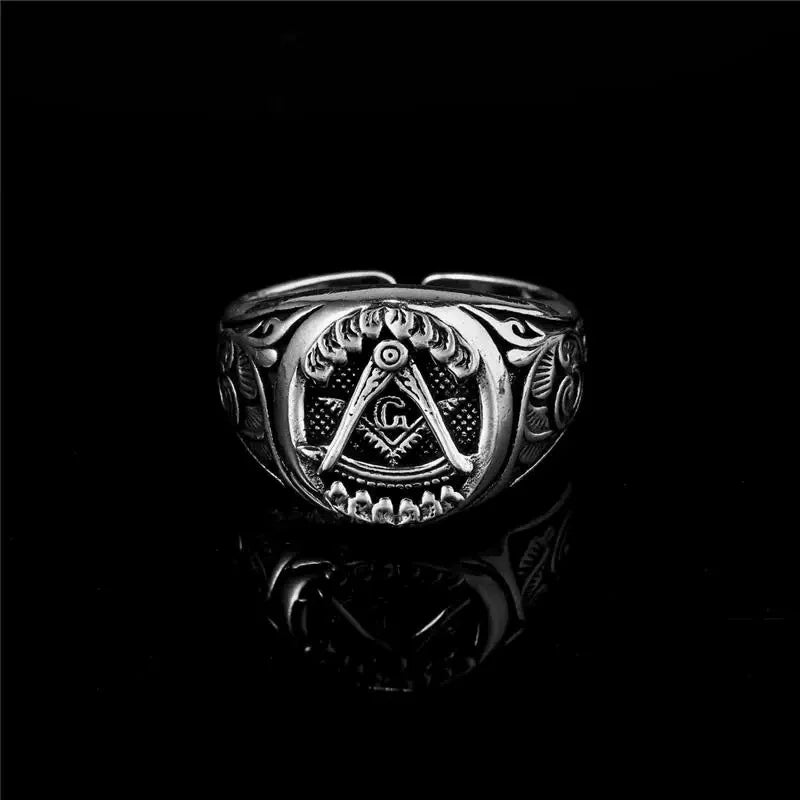 Front of scrollwork Masonic signet on black reflective surface