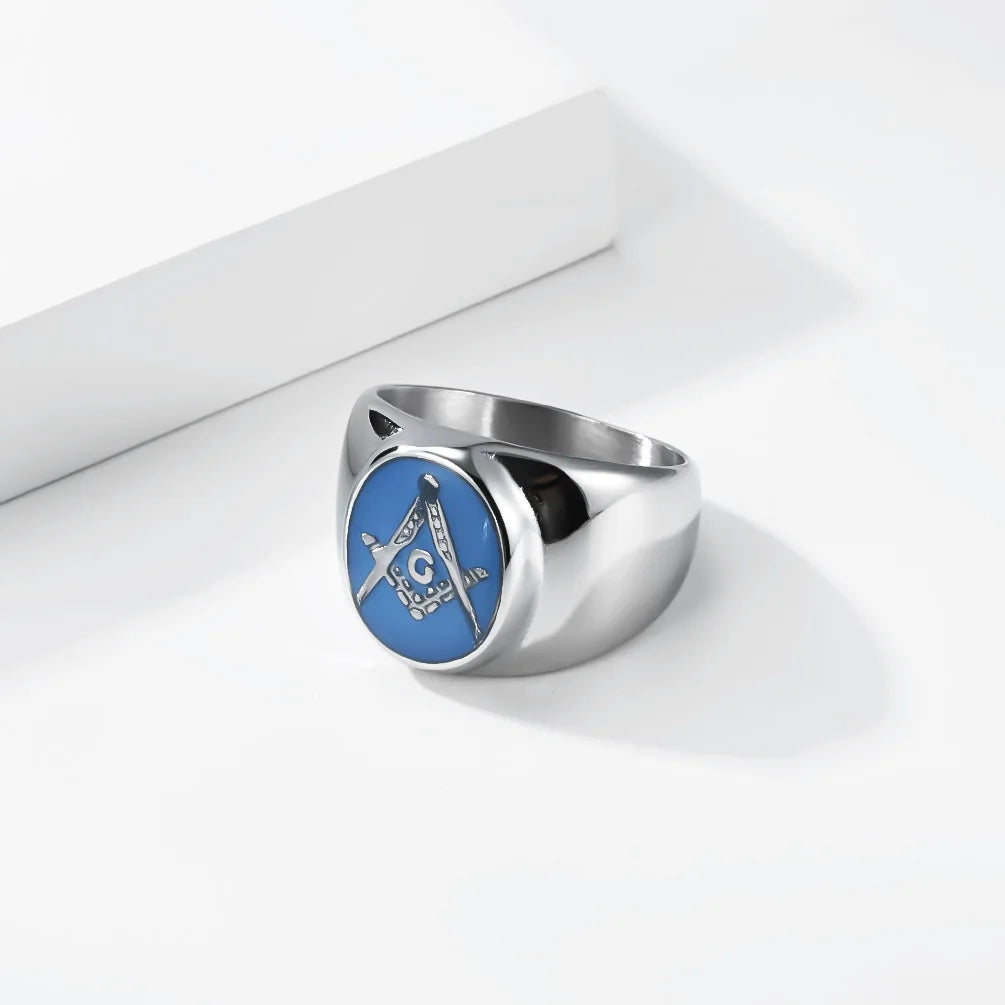 Angled silver-tone blue signet with gold-tone Square and Compasses