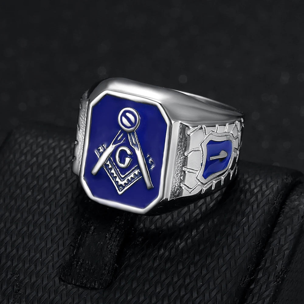 Silver-tone blue shield-shoulder Masonic ring on dark cloth