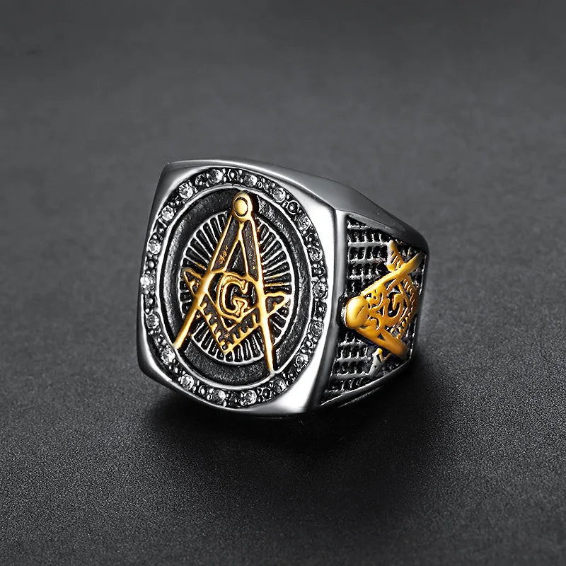 Silver-tone Masonic ring with gold-tone emblem and dark sunburst face