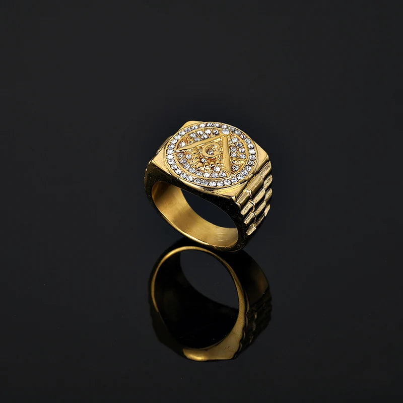 Rear angle of gold-tone halo Masonic ring on dark surface