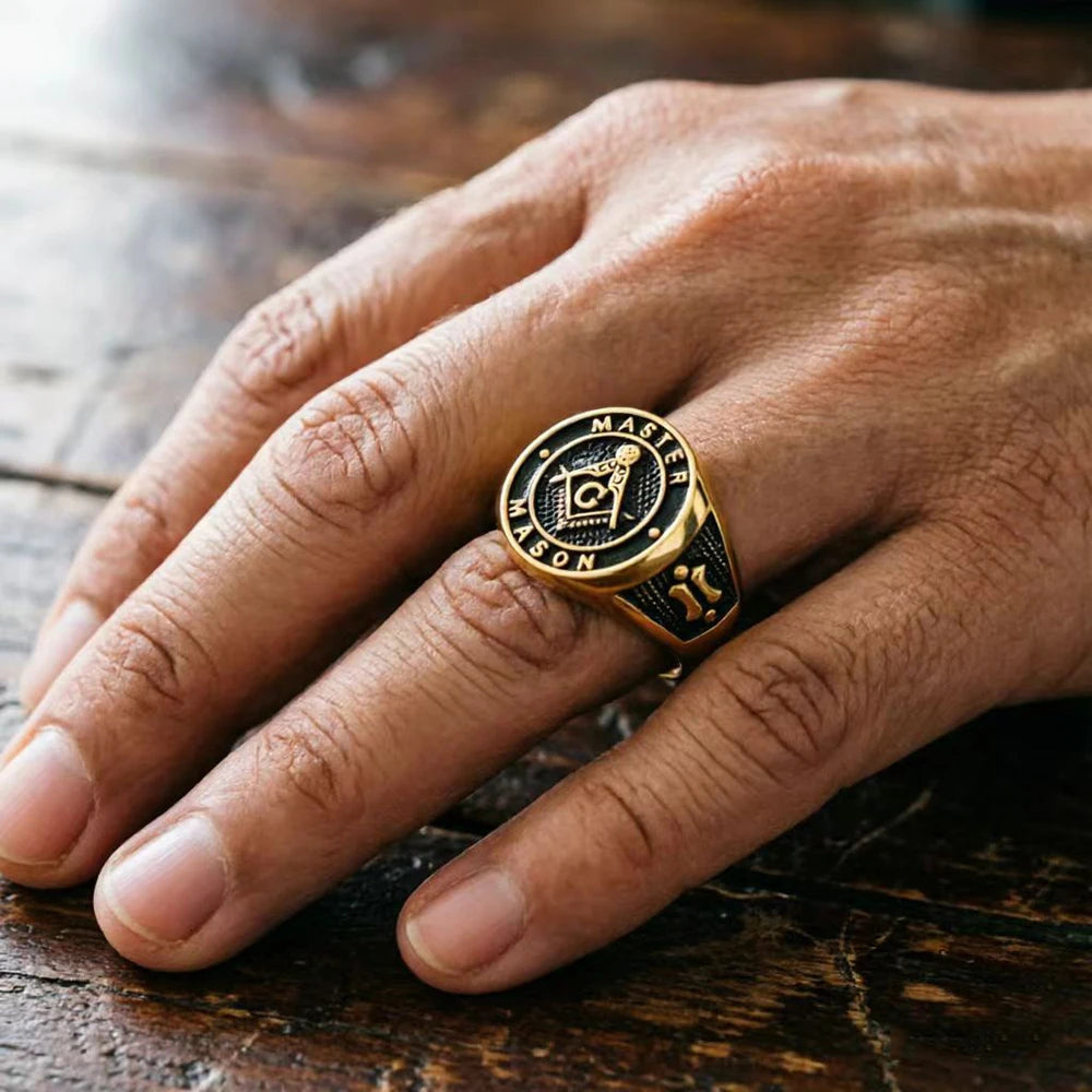 Top view of gold-tone Master Mason ring worn on a finger