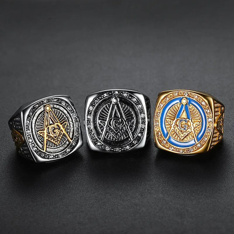 Blue and silver-tone Masonic signets together on dark surface