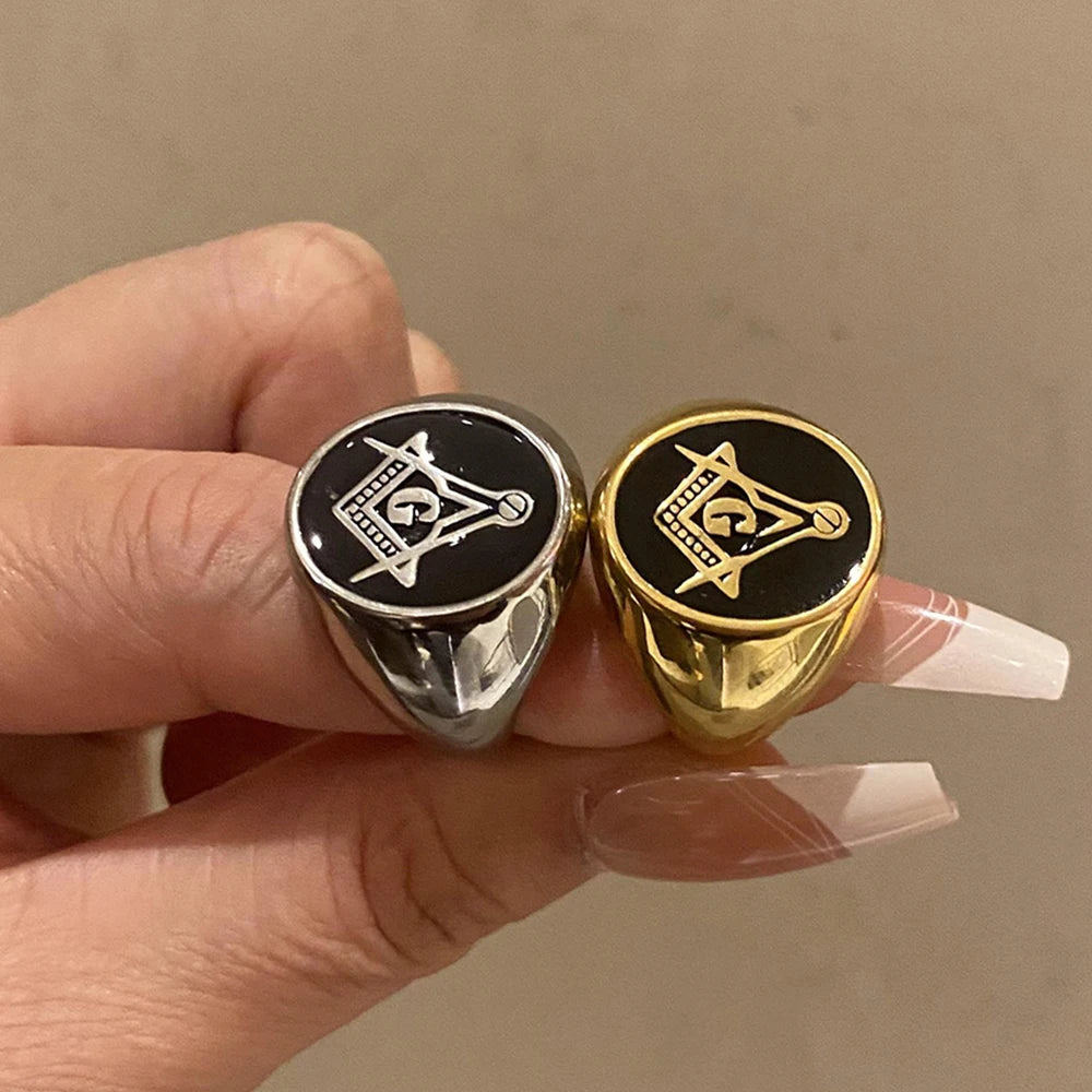 Gold-tone and silver-tone black-face Masonic rings held together