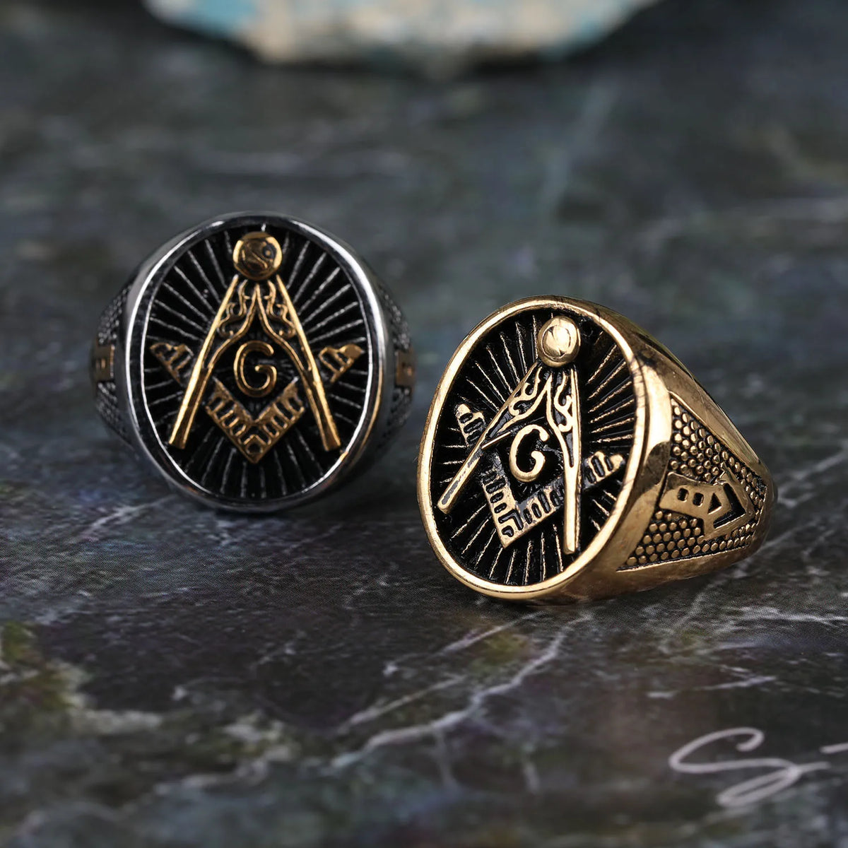 Silver-tone Masonic signets showing gold-tone emblems and shoulders