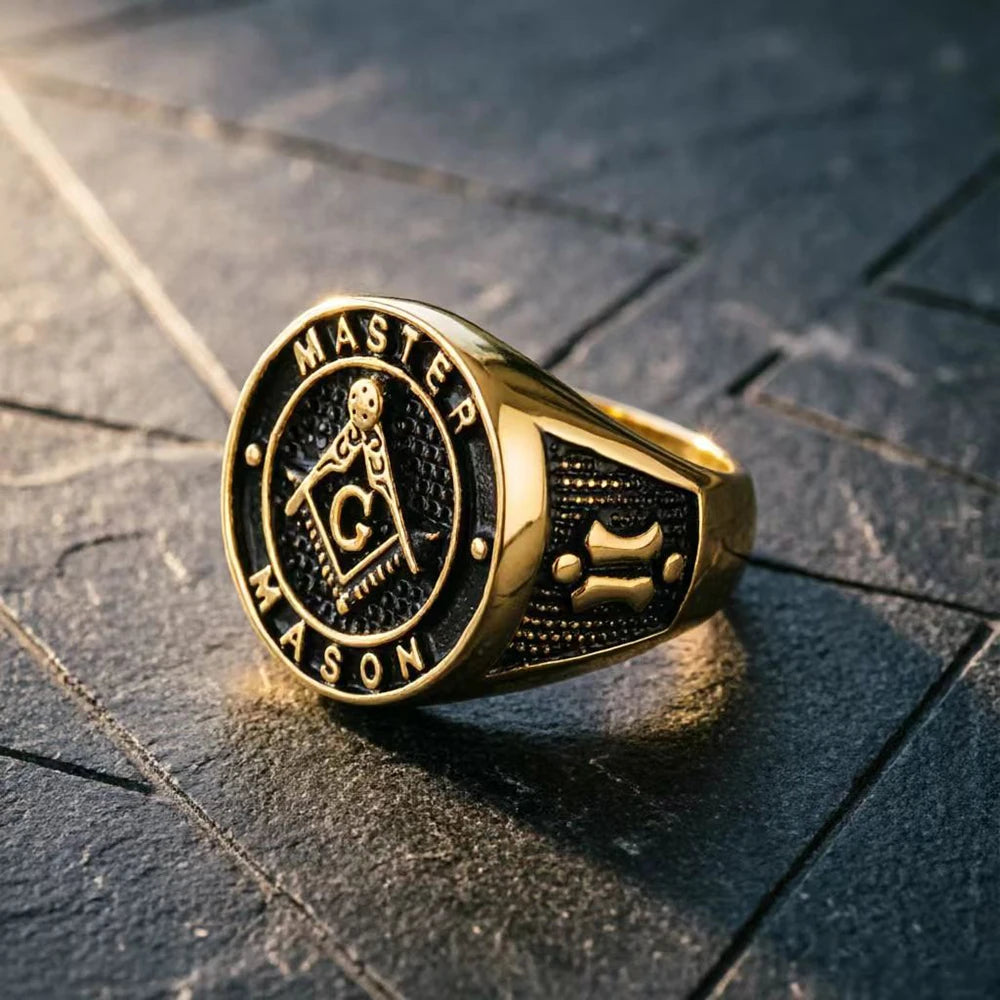 Gold-tone Master Mason ring with black round face on dark stone