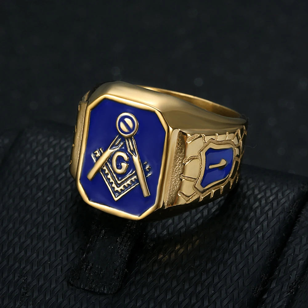 Gold-tone blue shield-shoulder Masonic ring on dark cloth