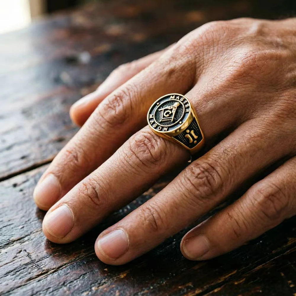 Gold-tone Master Mason ring worn on a hand