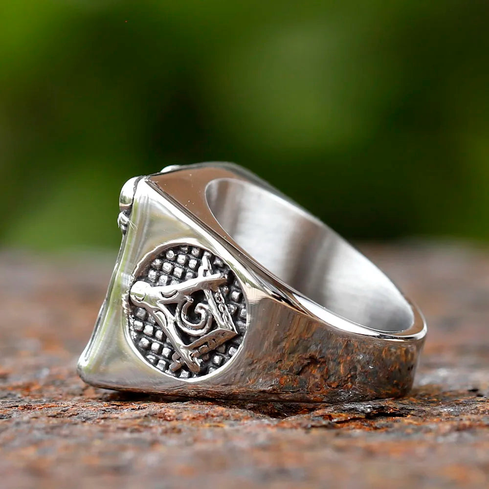 Side detail of antiqued Masonic pillar ring on wood